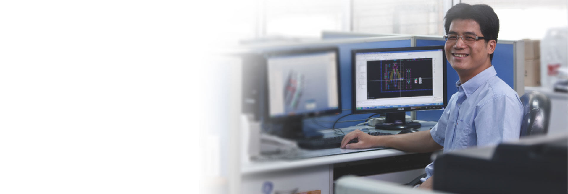 Packaging engineer reviewing a bottle design at a CAD workstation
